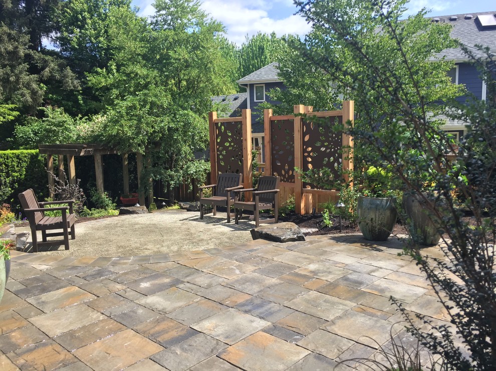 Example of a mid-sized mountain style backyard concrete paver patio design in Seattle
