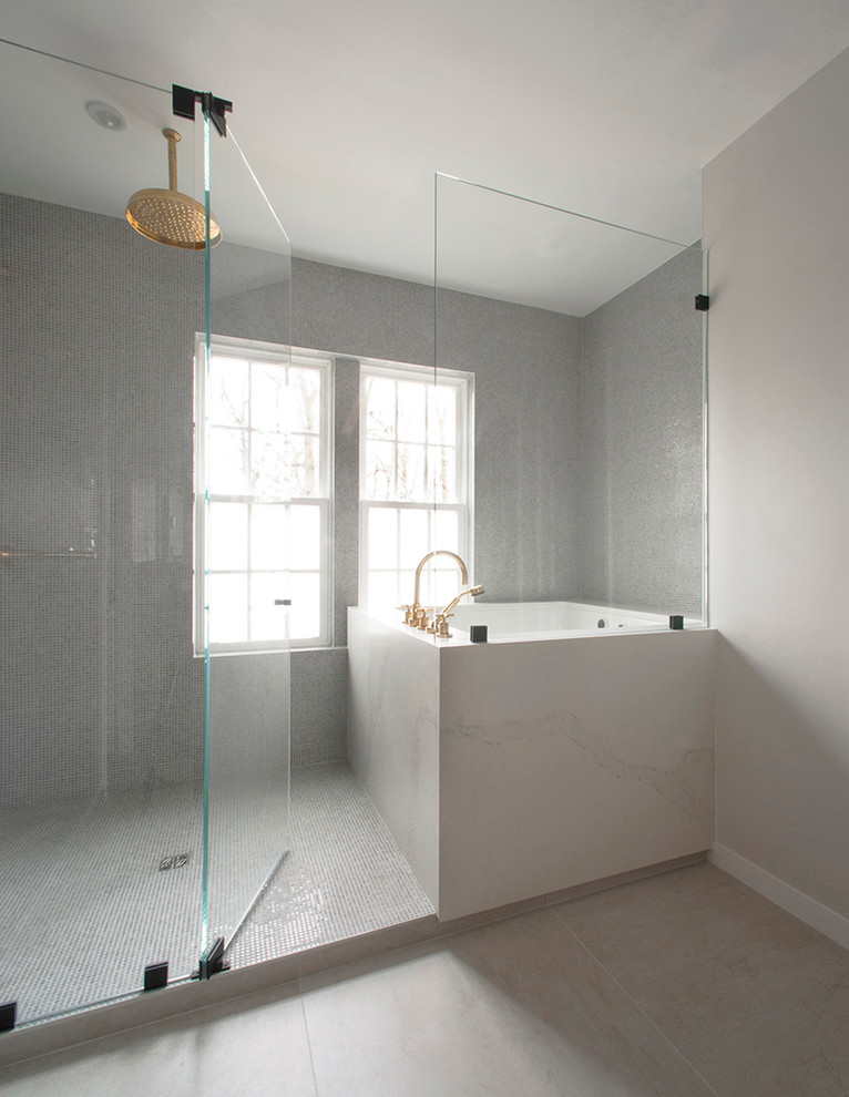 Modern wet room bathroom in DC Metro with a drop-in tub, grey walls and a hinged shower door.