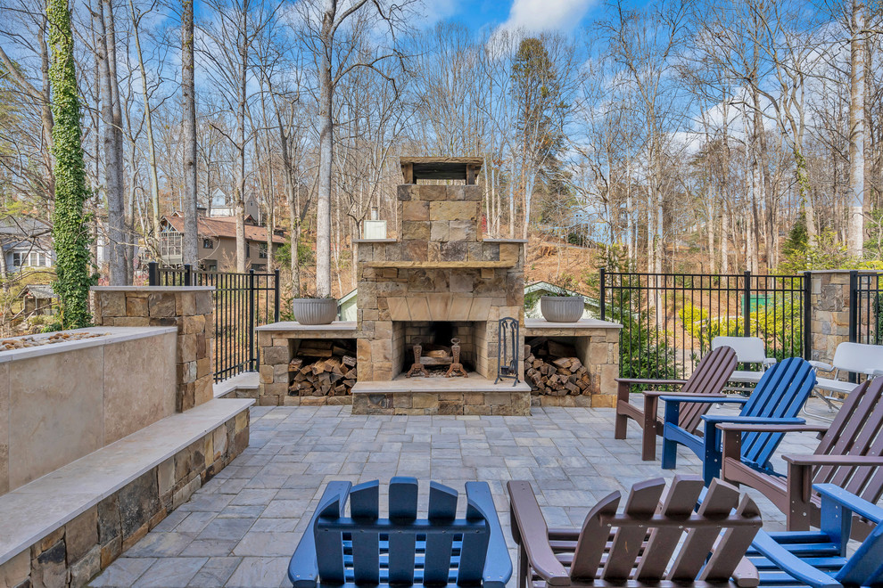 Design ideas for a large arts and crafts backyard patio in Other with with fireplace, natural stone pavers and no cover.