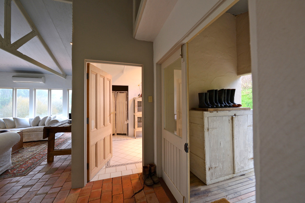 Photo of a country mudroom in Adelaide with orange floor.