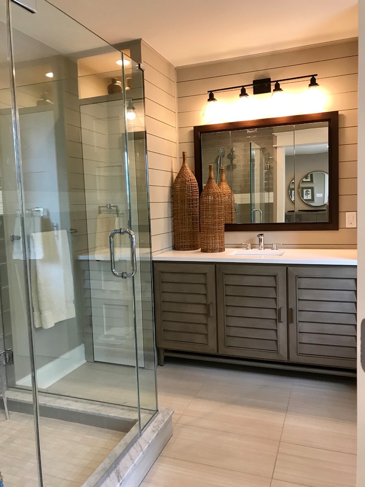 Inspiration for a small country master bathroom in Philadelphia with louvered cabinets, distressed cabinets, a corner shower, a one-piece toilet, beige tile, ceramic tile, beige walls, porcelain floors, a drop-in sink, engineered quartz benchtops, beige floor, a hinged shower door and white benchtops.