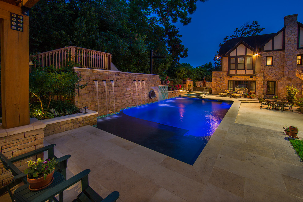 Photo of a large country side yard rectangular lap pool in Austin with a water slide and natural stone pavers.