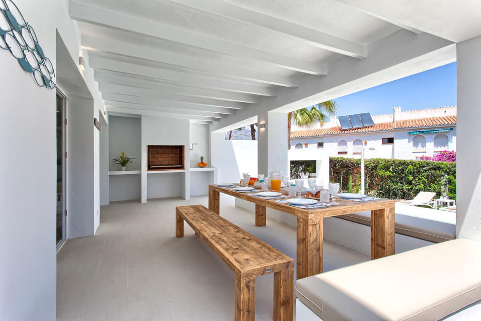 Inspiration for a mid-sized beach style backyard verandah in Other with a roof extension.