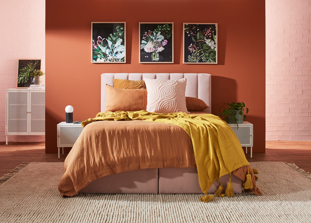 Photo of a mid-sized contemporary master bedroom in Sydney with orange walls, vinyl floors and brown floor.