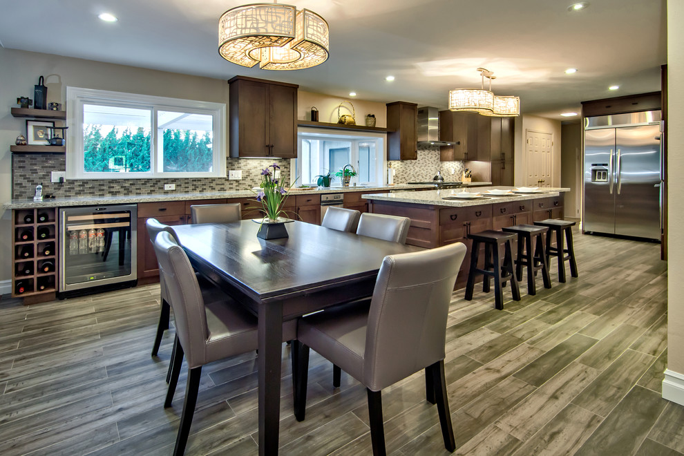 Photo of a large asian u-shaped eat-in kitchen in San Francisco with a drop-in sink, stainless steel appliances and with island.