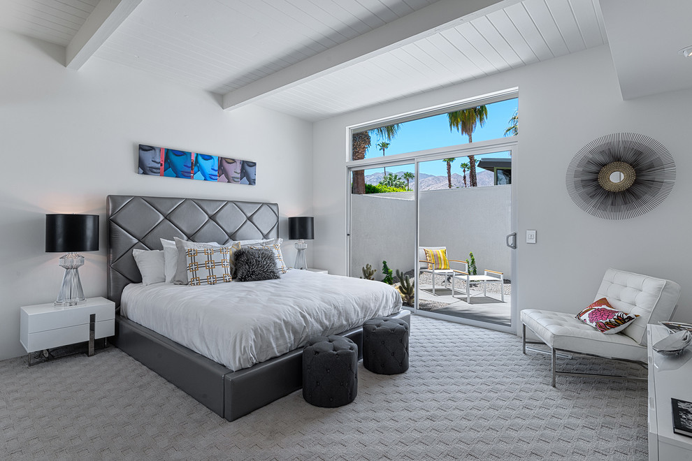 Midcentury bedroom in Los Angeles with white walls and carpet.