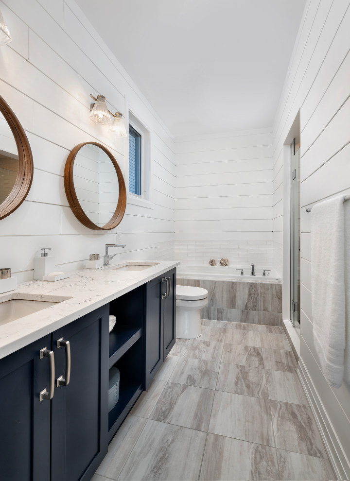 Inspiration for a country master bathroom in Ottawa with shaker cabinets, black cabinets, a drop-in tub, an alcove shower, white walls, an undermount sink, brown floor, a hinged shower door and multi-coloured benchtops.