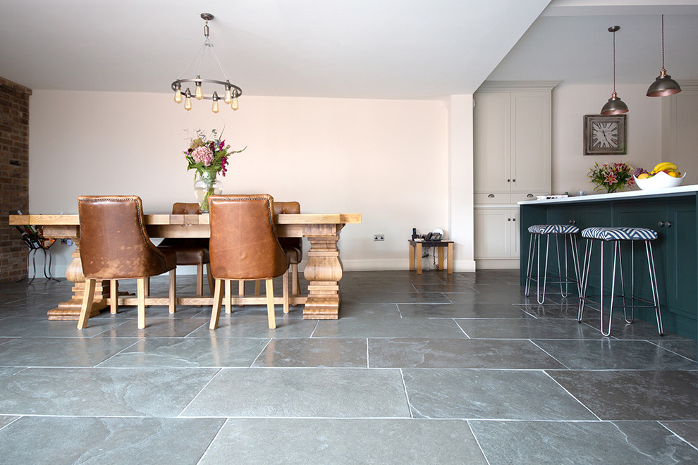Inspiration for a mid-sized country u-shaped kitchen in Other with limestone floors, with island and green floor.