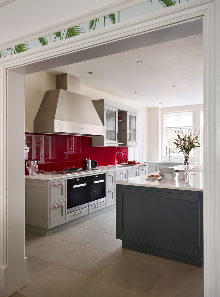 Design ideas for a large transitional eat-in kitchen in London with quartzite benchtops, red splashback, glass sheet splashback, panelled appliances, with island and grey cabinets.