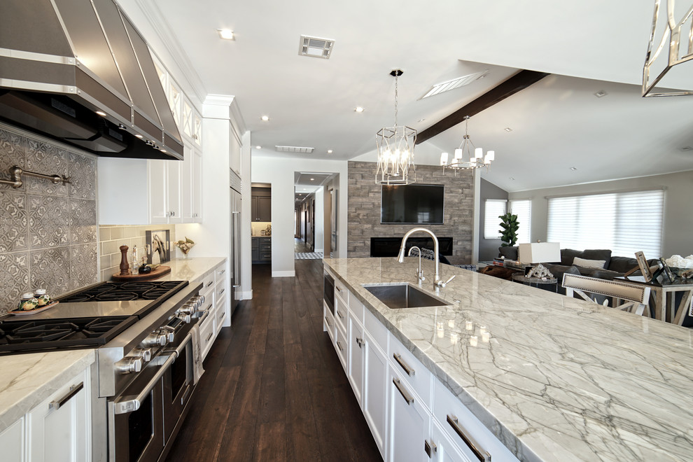 Inspiration for a large transitional galley open plan kitchen in San Luis Obispo with an undermount sink, recessed-panel cabinets, white cabinets, quartzite benchtops, grey splashback, ceramic splashback, stainless steel appliances, dark hardwood floors, with island, brown floor and green benchtop.