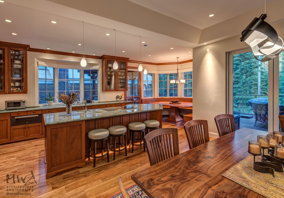 Inspiration for a large transitional l-shaped open plan kitchen in Other with an undermount sink, recessed-panel cabinets, brown cabinets, medium hardwood floors, with island, brown floor and green benchtop.