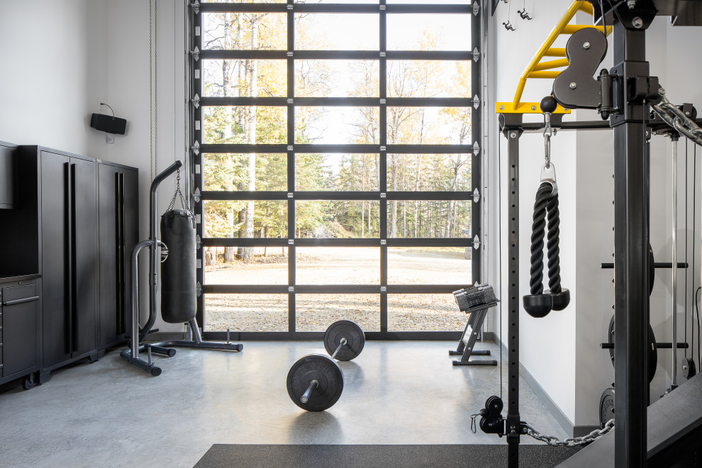 This is an example of a contemporary home gym in Edmonton with white walls, concrete floors and grey floor.