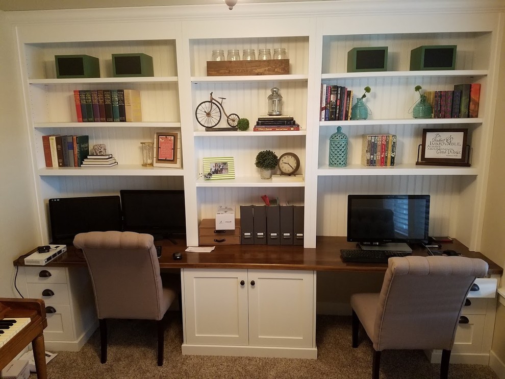 Mid-sized transitional study room in Salt Lake City with beige walls, carpet, no fireplace, a built-in desk and beige floor.