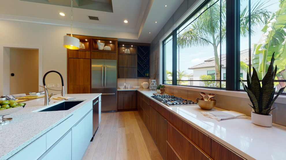 This is an example of a contemporary kitchen in Tampa with louvered cabinets and with island.