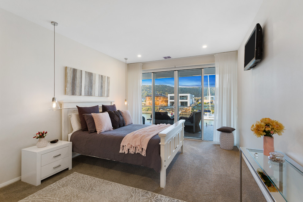 Design ideas for a large contemporary master bedroom in Melbourne with beige walls, carpet, no fireplace and brown floor.