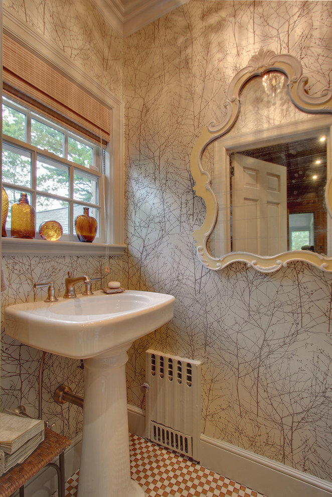 Inspiration for a small traditional powder room in New York with a pedestal sink.