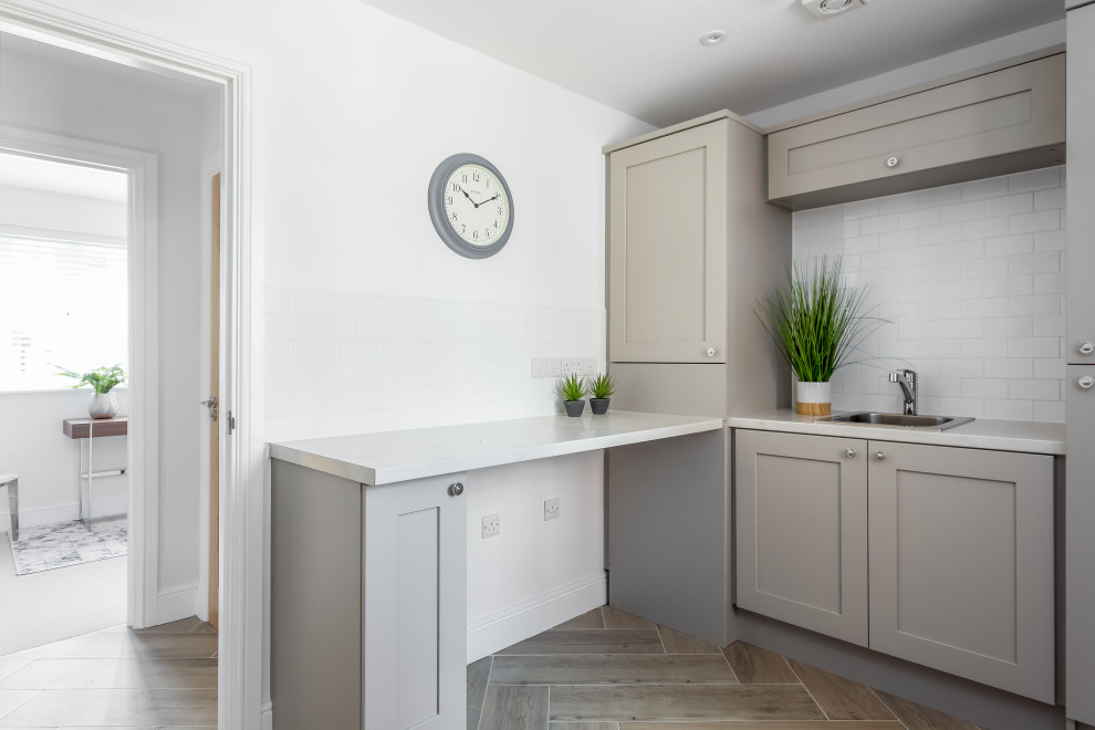 This is an example of a transitional laundry room in Dorset.
