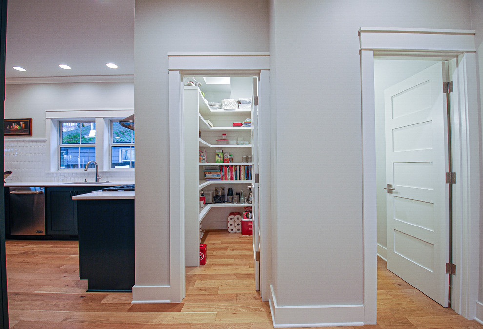 Photo of a large traditional walk-in wardrobe in Portland with medium hardwood floors.