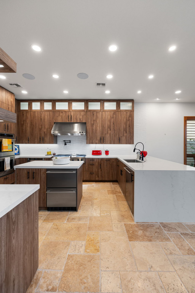 Mountain style l-shaped slate floor and beige floor enclosed kitchen photo with a single-bowl sink, flat-panel cabinets, medium tone wood cabinets, quartzite countertops, white backsplash, glass sheet backsplash, stainless steel appliances, a peninsula and white countertops