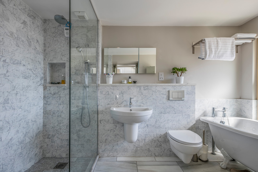 Inspiration for a traditional bathroom in Dublin with a wall-mount toilet, white tile, porcelain tile and multi-coloured walls.