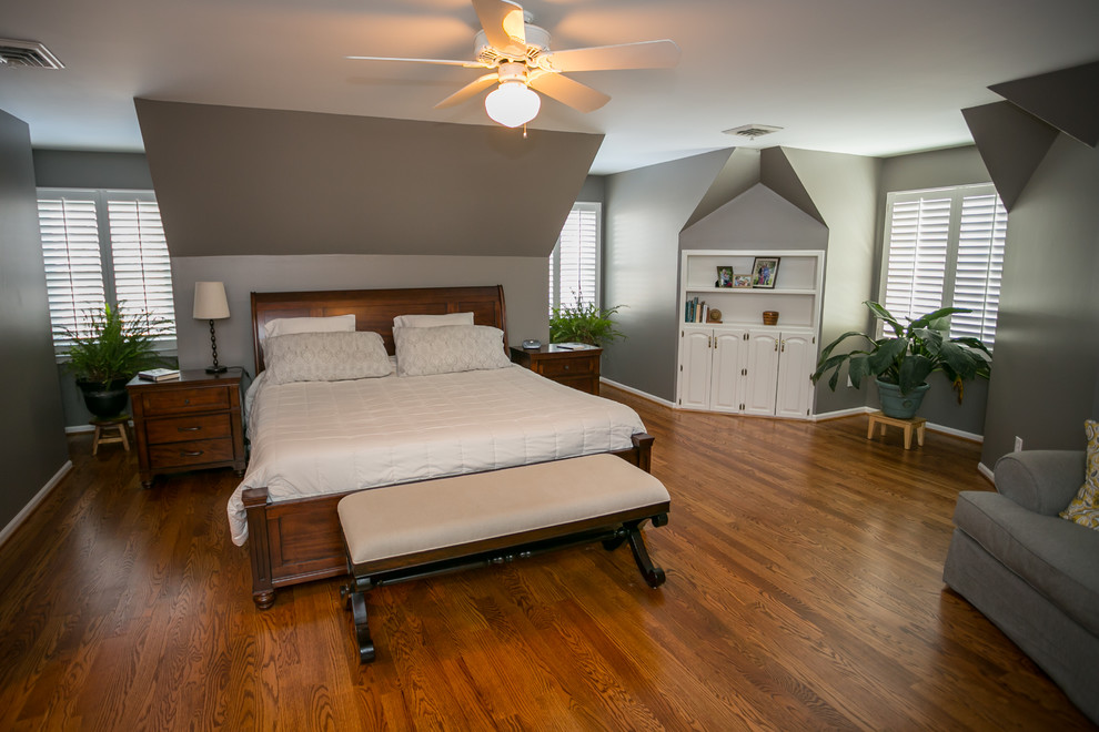 Inspiration for a large modern master bedroom in Kansas City with grey walls and medium hardwood floors.