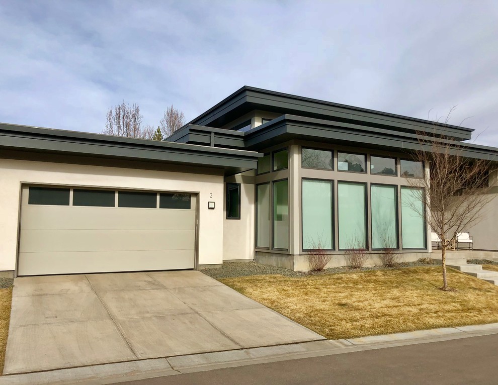 Design ideas for a mid-sized contemporary attached two-car garage in Denver.