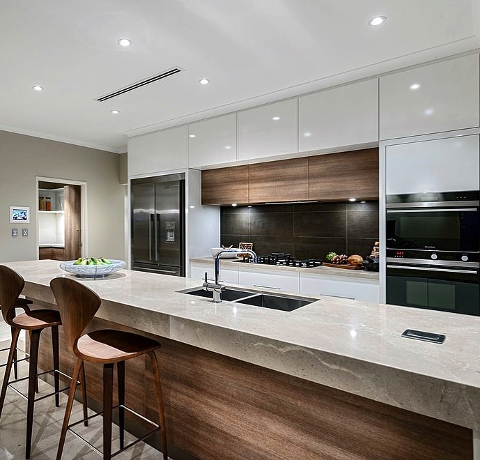 Photo of a modern galley open plan kitchen in San Francisco with a double-bowl sink, flat-panel cabinets, white cabinets, black splashback, stainless steel appliances, with island and beige benchtop.