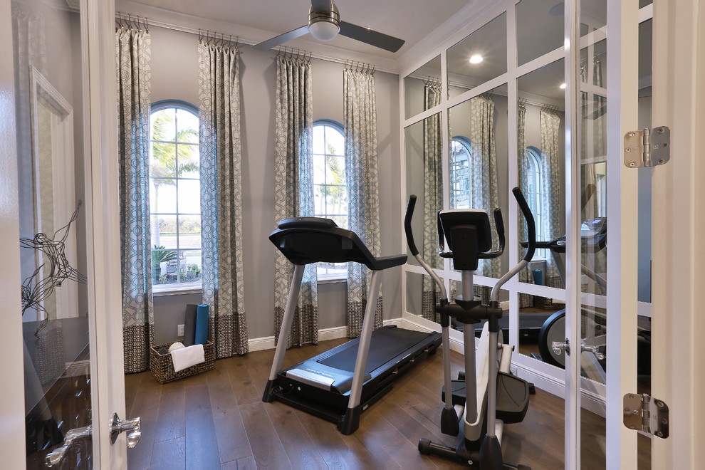 Inspiration for a small traditional multipurpose gym in Tampa with grey walls, medium hardwood floors and brown floor.