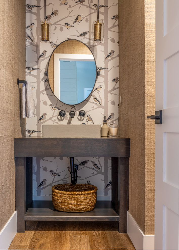 Photo of a small traditional cloakroom in Denver with dark wood cabinets, medium hardwood flooring, a console sink, wooden worktops, brown floors, a built in vanity unit and wallpapered walls.