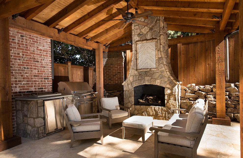 Photo of a large country backyard patio in Atlanta with a fire feature, natural stone pavers and a gazebo/cabana.