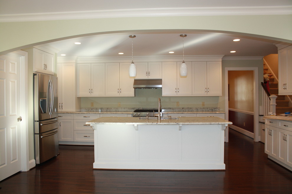 Mid-sized transitional u-shaped dark wood floor eat-in kitchen photo in Charlotte with an undermount sink, recessed-panel cabinets, white cabinets, granite countertops, stainless steel appliances and an island