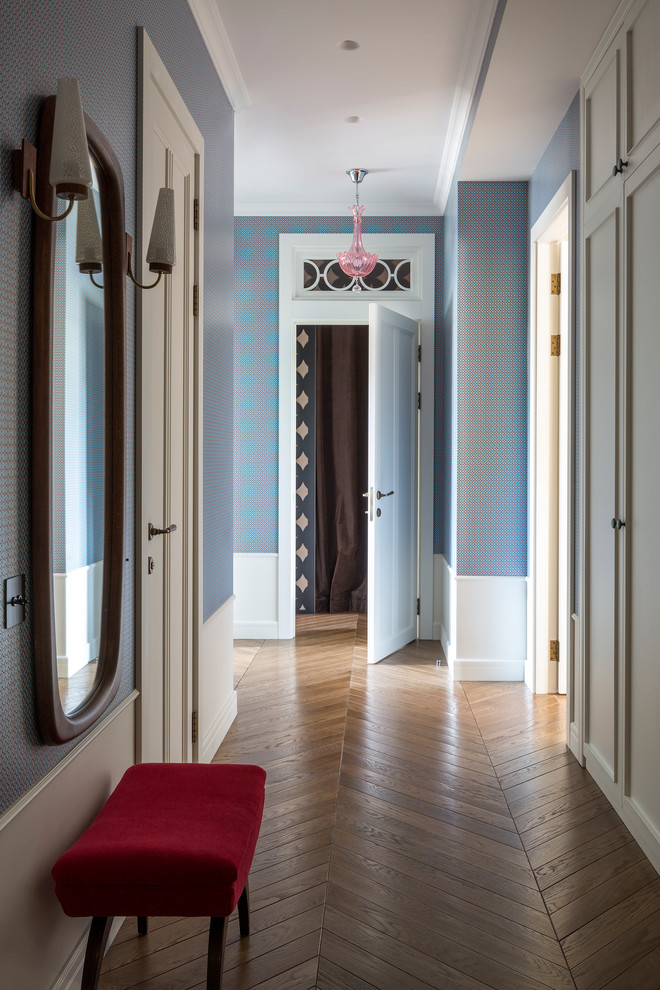 This is an example of a midcentury hallway in Moscow with blue walls, medium hardwood floors and brown floor.