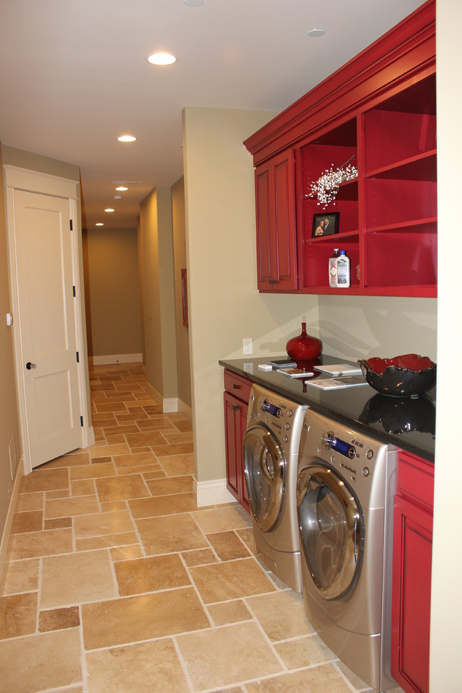 Inspiration for a mid-sized eclectic single-wall dedicated laundry room in Grand Rapids with recessed-panel cabinets, red cabinets, quartz benchtops, beige walls, ceramic floors, a side-by-side washer and dryer and an undermount sink.