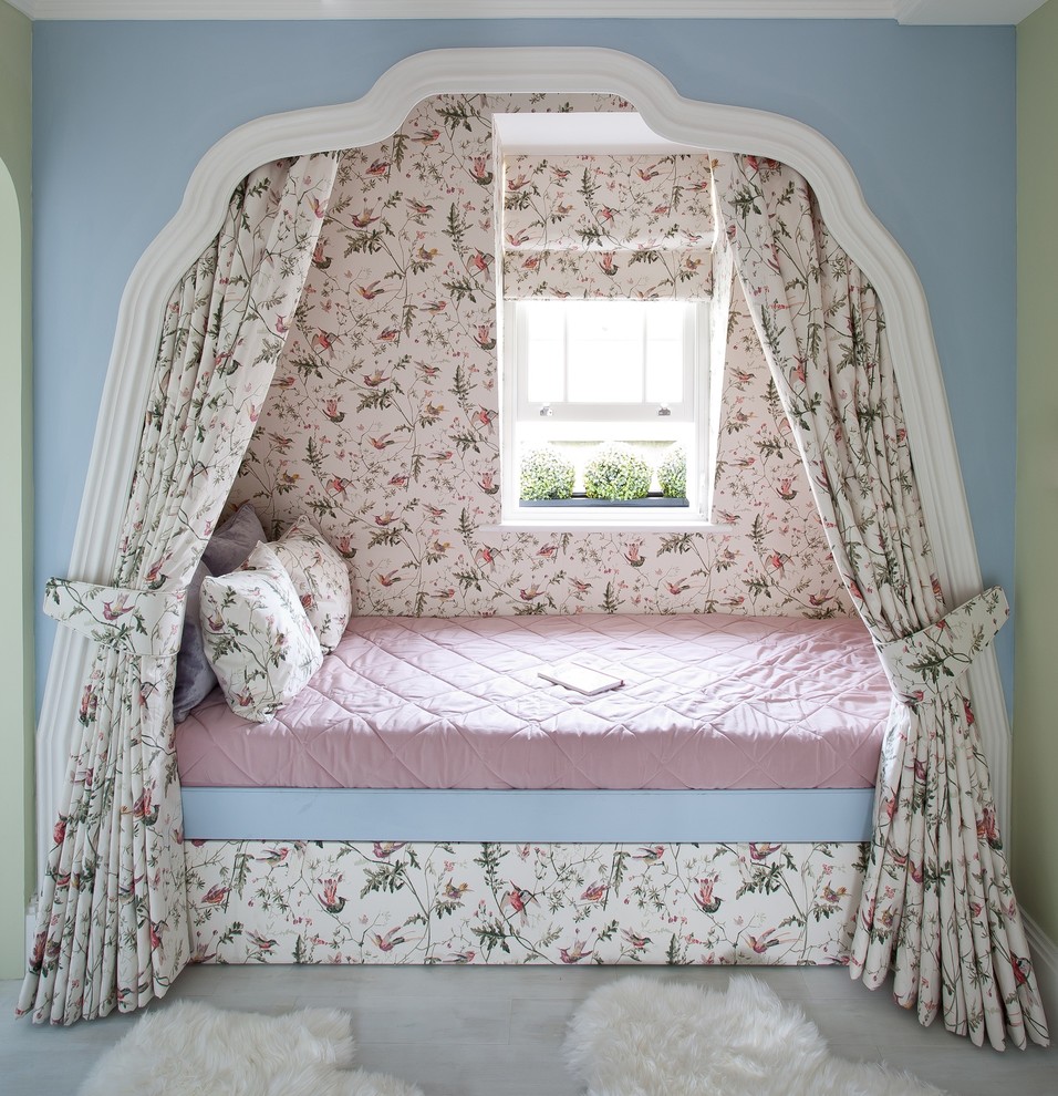 This is an example of a large traditional kids' bedroom for girls and kids 4-10 years old in London with multi-coloured walls and painted wood floors.