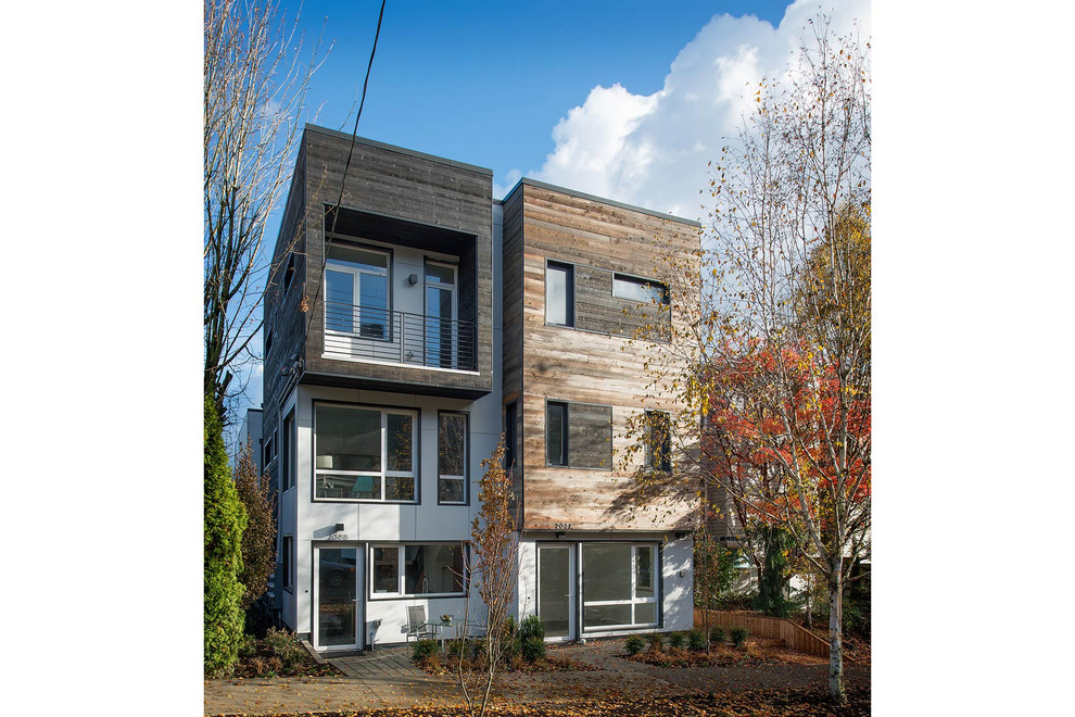 Mid-sized modern three-storey white house exterior in Seattle with mixed siding and a flat roof.
