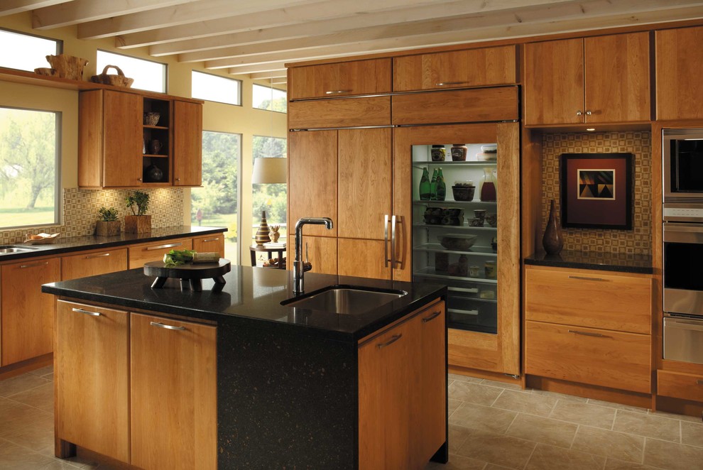 Photo of a large midcentury single-wall separate kitchen in Atlanta with an undermount sink, flat-panel cabinets, medium wood cabinets, quartz benchtops, multi-coloured splashback, mosaic tile splashback, stainless steel appliances, travertine floors, with island, beige floor and black benchtop.
