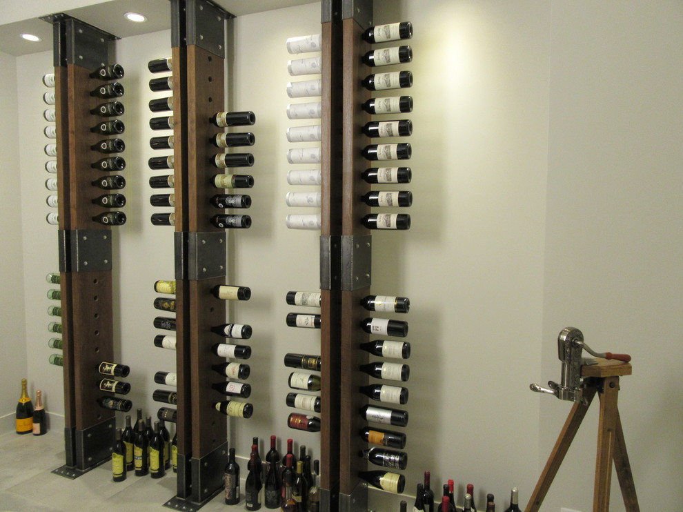 Inspiration for a large modern wine cellar in San Francisco with porcelain floors, storage racks and grey floor.
