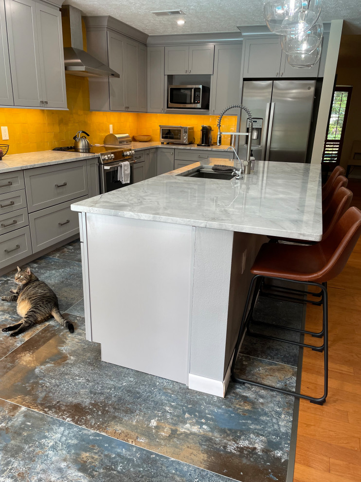 Inspiration for a mid-sized transitional l-shaped kitchen in Other with an undermount sink, shaker cabinets, grey cabinets, yellow splashback, ceramic splashback, stainless steel appliances, porcelain floors, with island and multi-coloured floor.