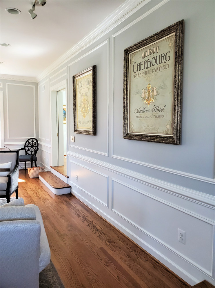 Large traditional formal enclosed living room in DC Metro with grey walls, medium hardwood floors, a standard fireplace, a brick fireplace surround and decorative wall panelling.