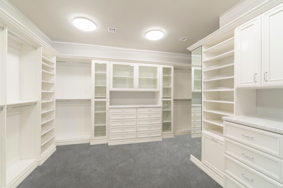 Design ideas for a large traditional gender-neutral walk-in wardrobe in Denver with recessed-panel cabinets, white cabinets, carpet and grey floor.