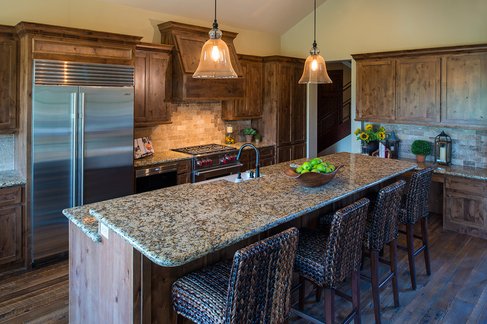 Eat-in kitchen - huge rustic single-wall medium tone wood floor eat-in kitchen idea in Phoenix with a farmhouse sink, flat-panel cabinets, dark wood cabinets, granite countertops, brown backsplash, subway tile backsplash, stainless steel appliances and an island