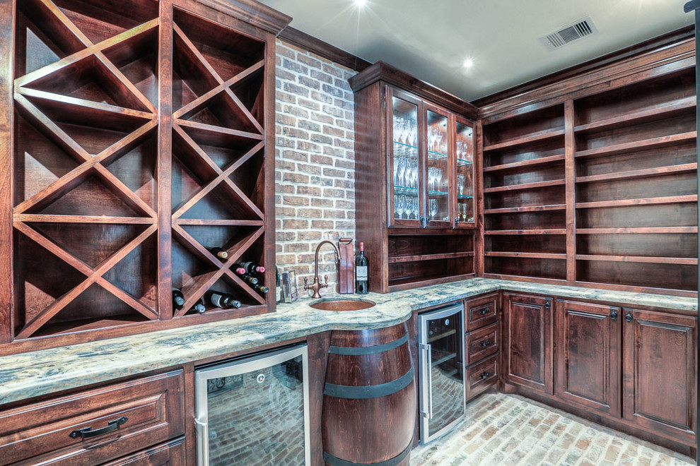 Photo of a large traditional wine cellar in Houston with brick floors and diamond bins.