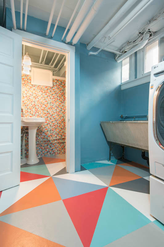 Photo of a large contemporary dedicated laundry room in Denver with a farmhouse sink, blue walls, a side-by-side washer and dryer and concrete floors.
