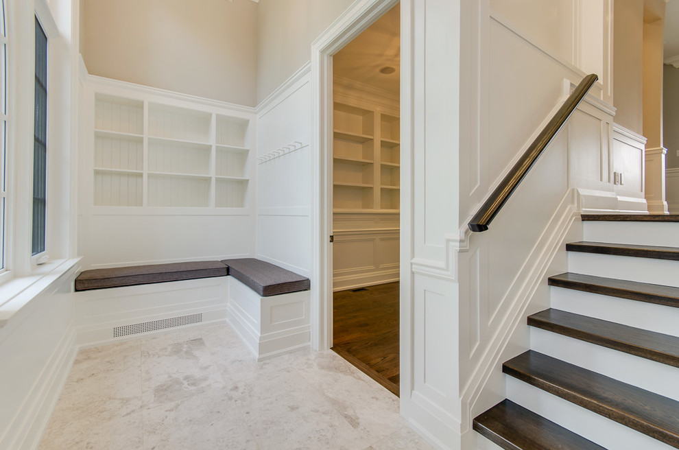 Inspiration for a large transitional granite floor foyer remodel in Toronto with white walls and a brown front door