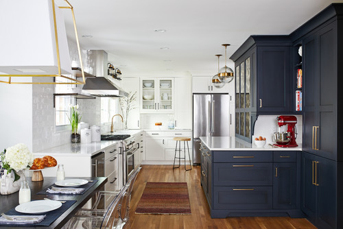 Premium low-VOC kitchen cabinets in Canada—two-tone navy and white design with brass hardware, quartz counters, and stainless appliances