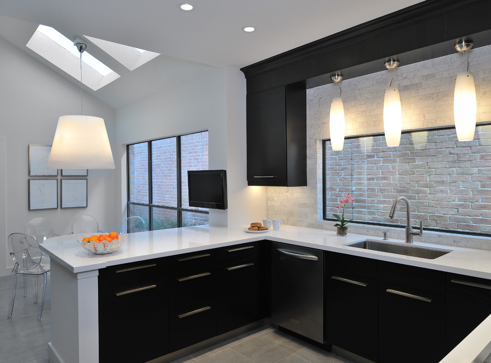 Photo of a contemporary eat-in kitchen in Houston with an undermount sink, flat-panel cabinets and black cabinets.