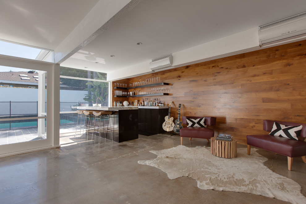 Design ideas for a contemporary family room in Orange County with concrete floors, brown walls and brown floor.