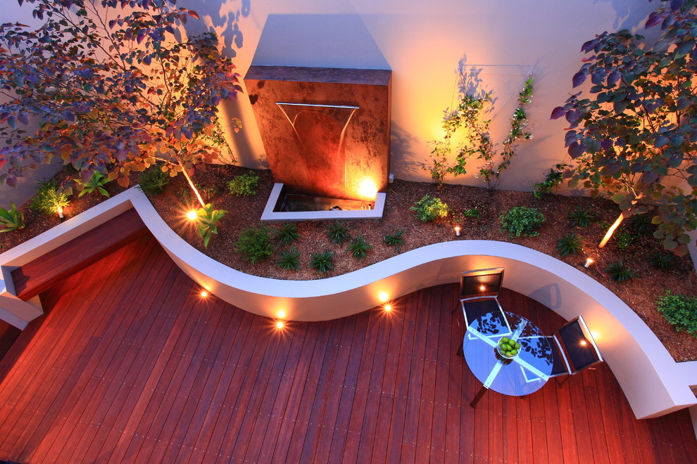 Design ideas for a contemporary deck in Sydney with a water feature.