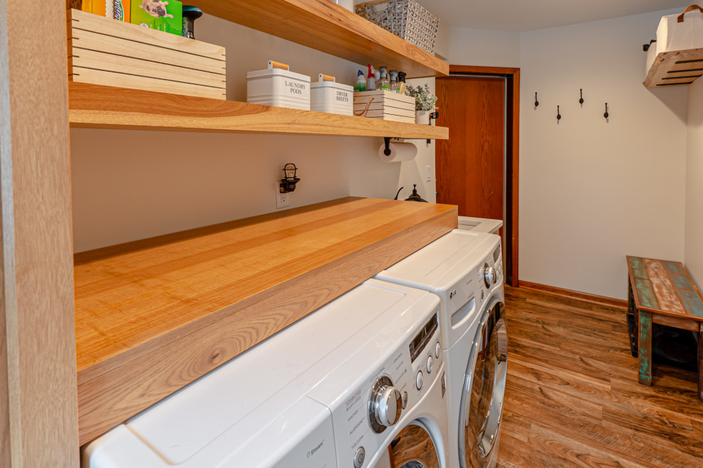 Small beach style single-wall medium tone wood floor and brown floor dedicated laundry room photo in Milwaukee with an undermount sink, shaker cabinets, medium tone wood cabinets, wood countertops, beige walls, a side-by-side washer/dryer and brown countertops