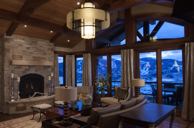 This is an example of a large contemporary formal enclosed living room in Salt Lake City with beige walls, dark hardwood floors, a standard fireplace, a stone fireplace surround and no tv.